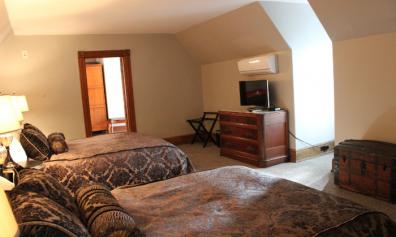 Room 302- Billiard Suite with two queen beds, pool table and seating area
